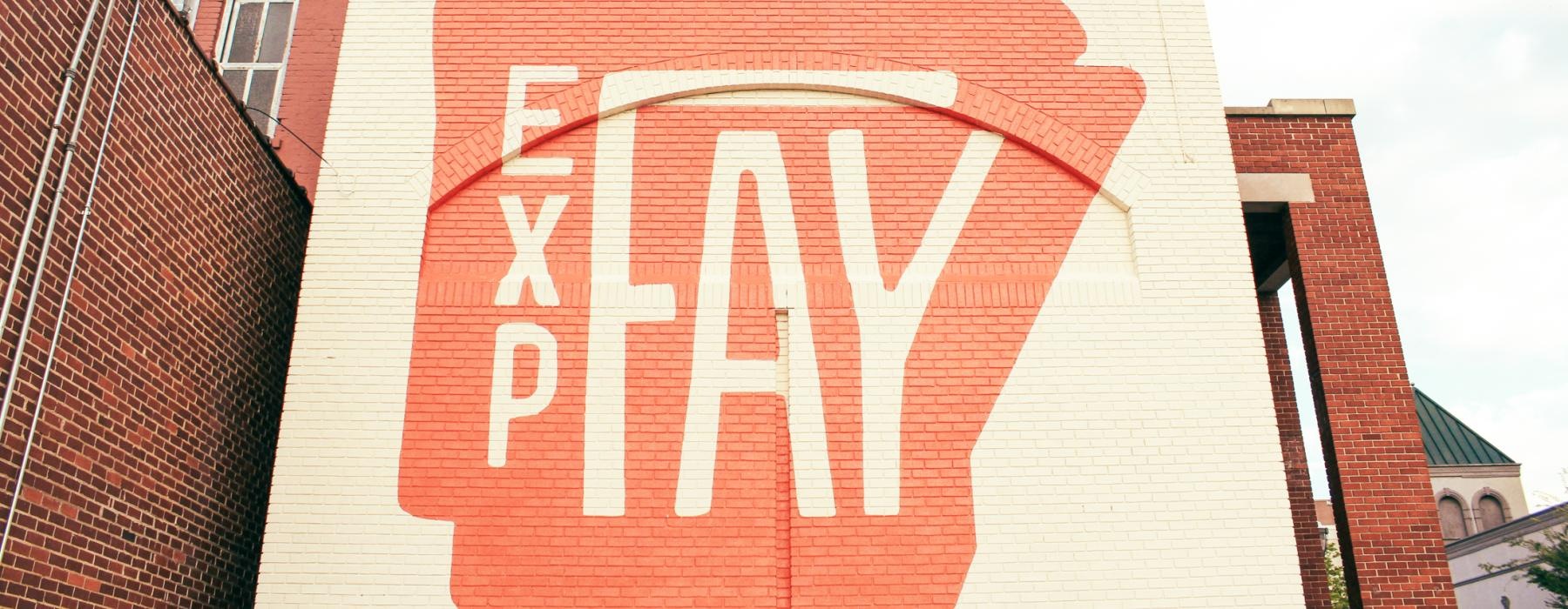 a large building with a red sign painted on